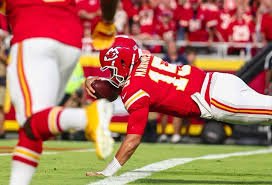 Mahomes stretches for a TD carry against the broncos